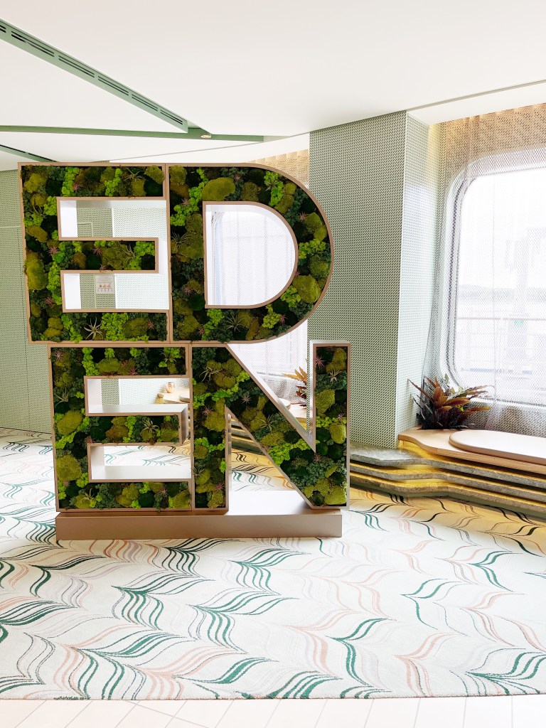 A large Eden sign with greenery within each letter.

