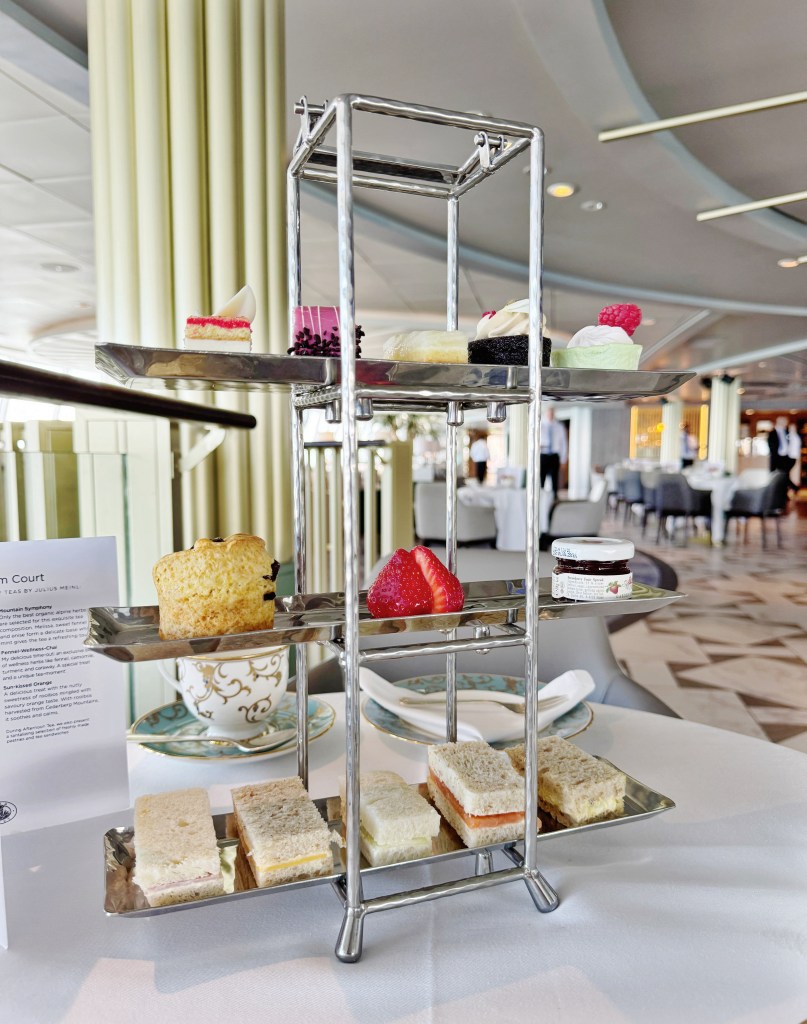 A three tiered tray of afternoon tea treats.
