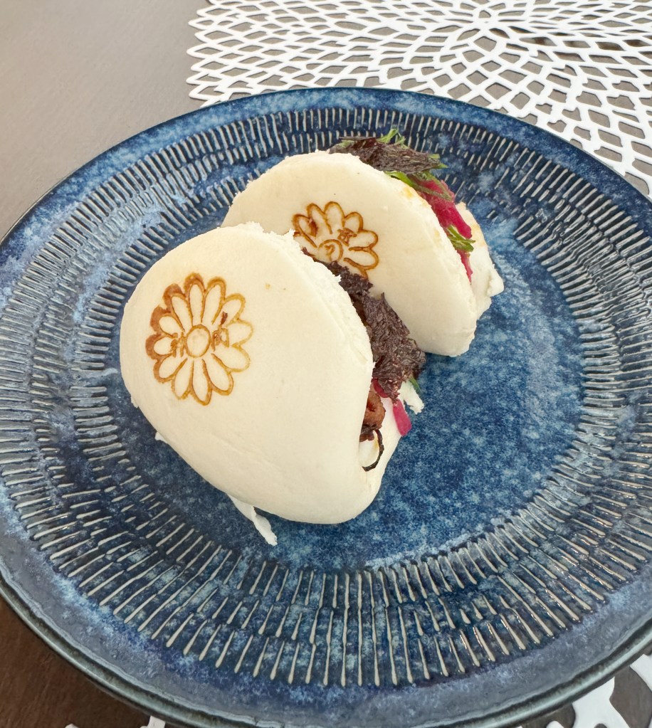 2 Bao Buns with a pattern printed on them.