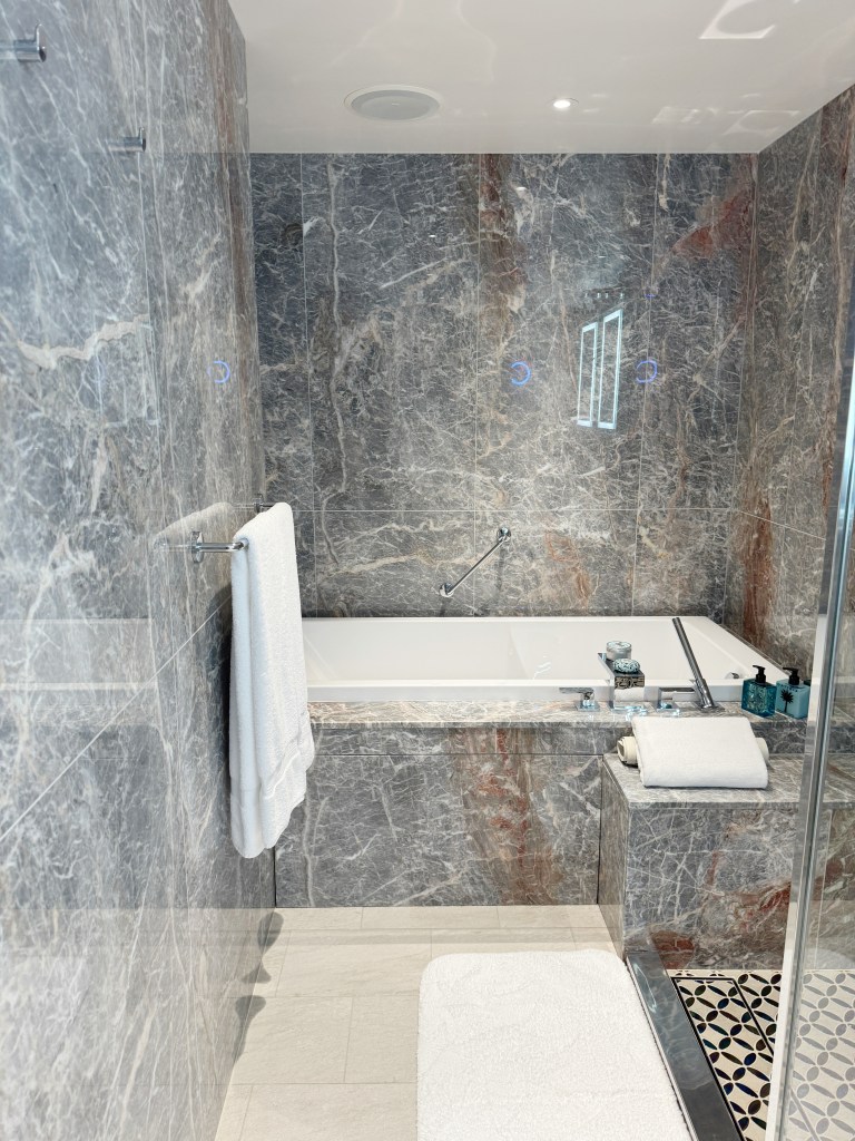 A luxury bathroom with a bath tub.