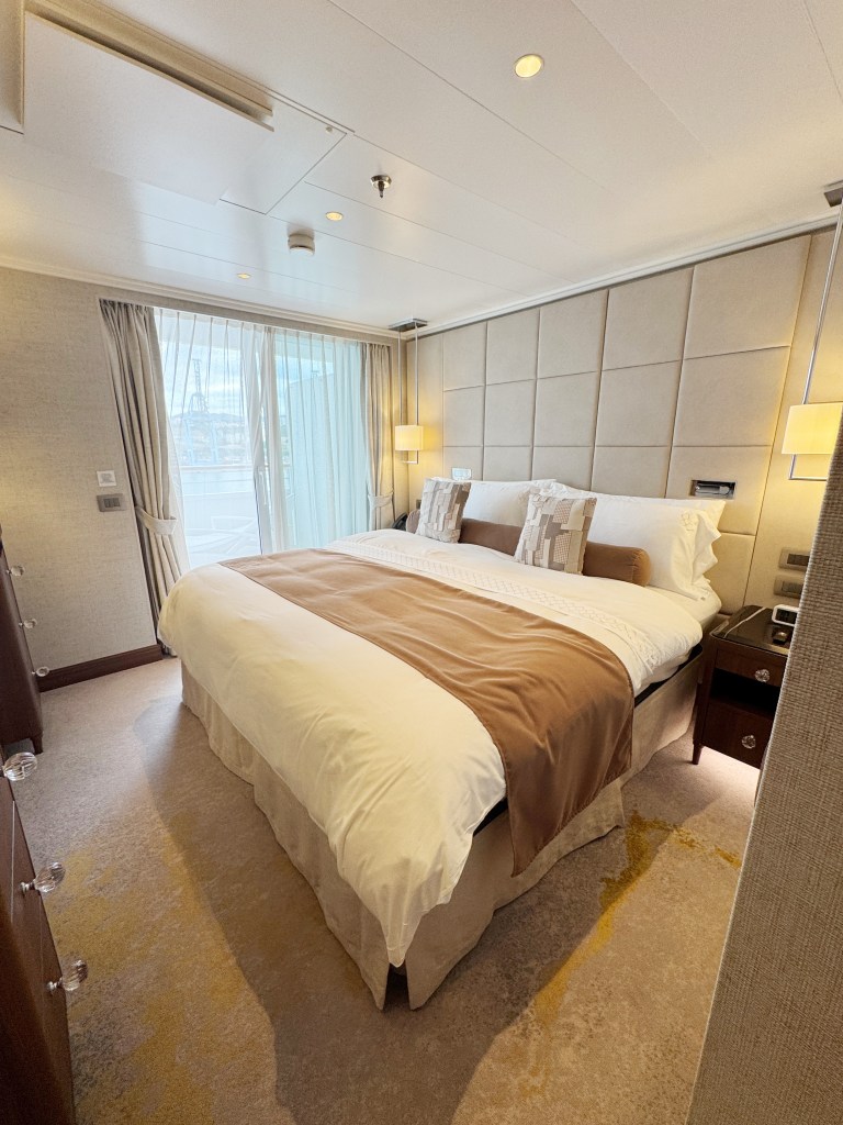 A large bed in a bedroom, with a door to the veranda.