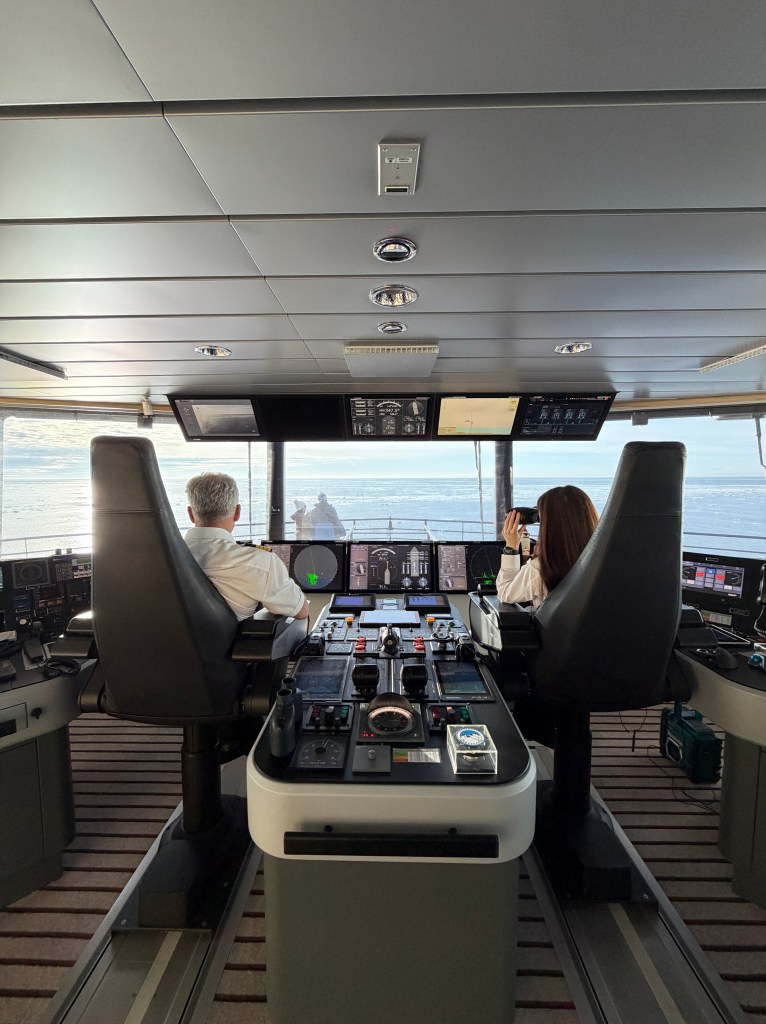 The Captain and an Officer sat in the 'driving seat' on the bridge on National Geographic Resolution