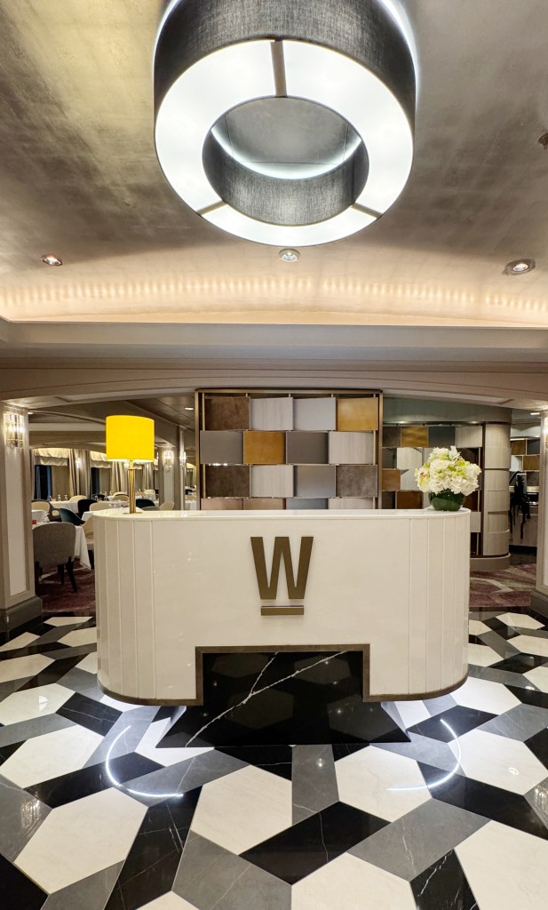 An entry podium in the entrance of the Waterside Restaurant with a big W on it.