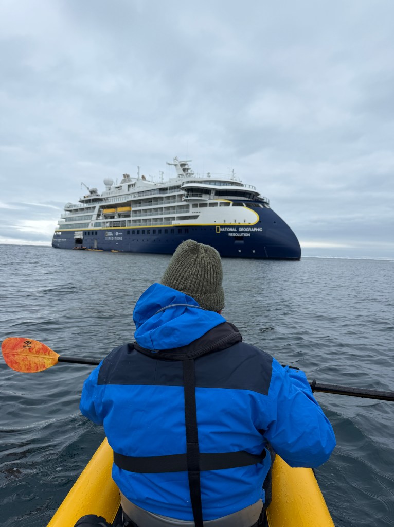 Kayaking in front of National Geographic Resolution