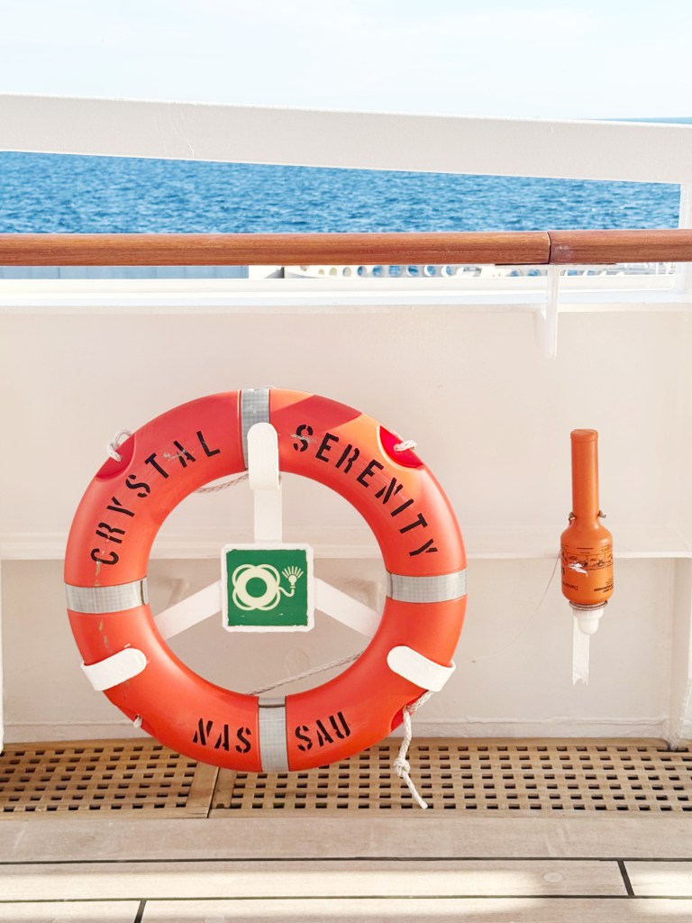 An orange Crystal Serenity Life ring on the promenade deck.