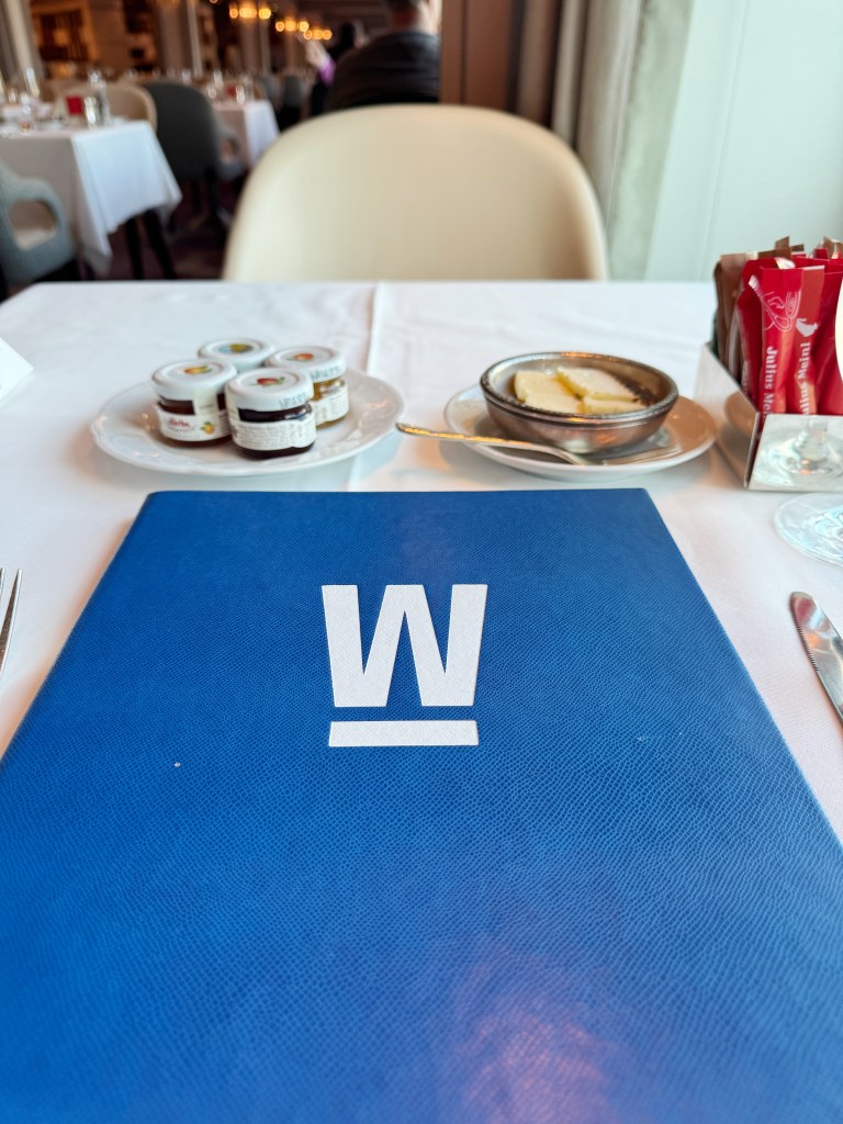 A large blue menu with a W on it, for the Waterside Restaurant.