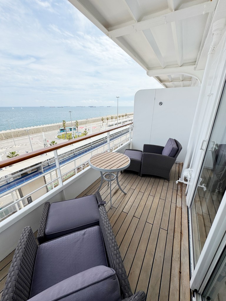 A spacious Veranda with two lounger seats and a table