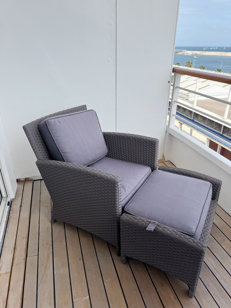a close up of a comfortable lounging chair and foot stool on the Veranda