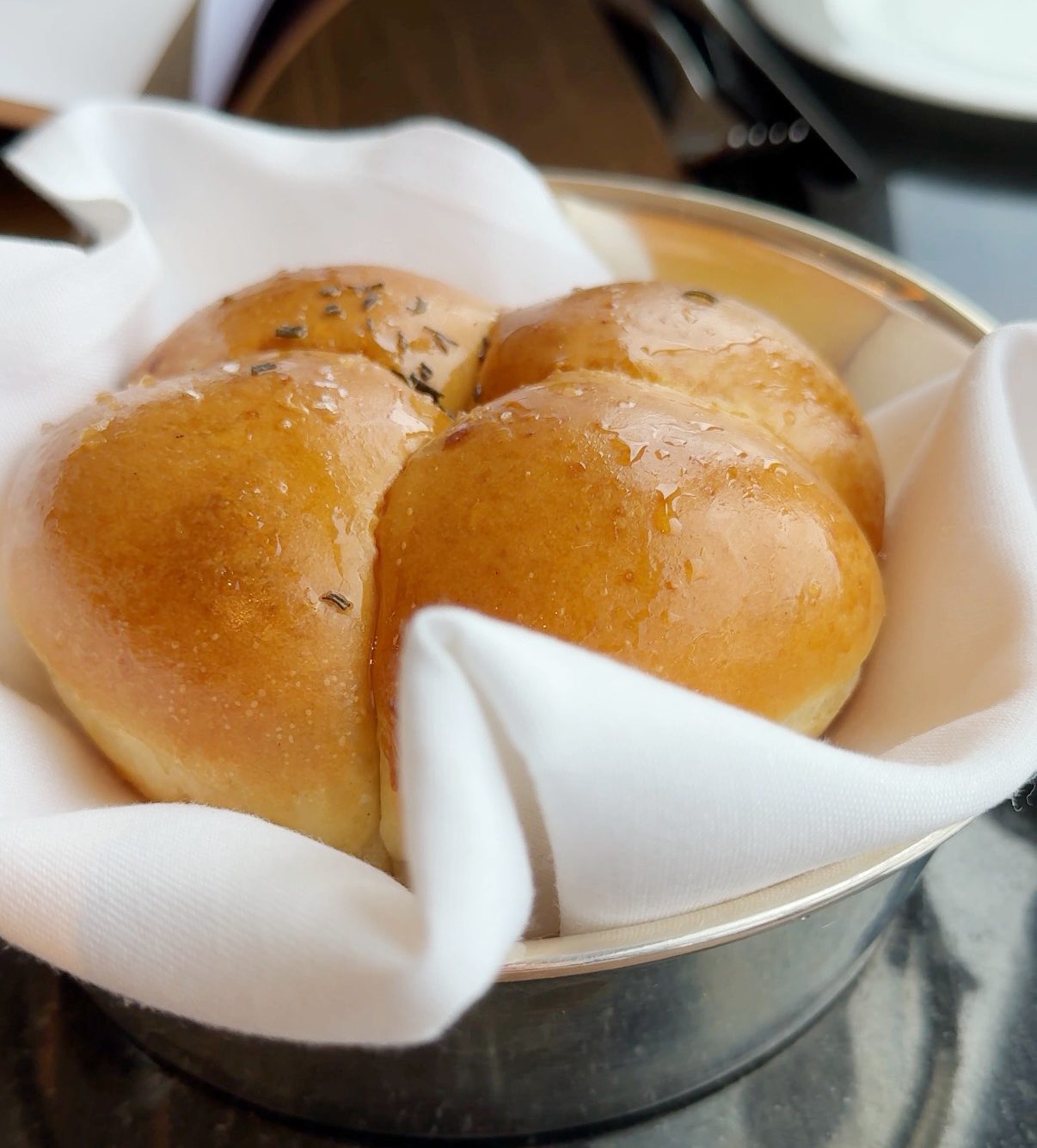 4 rolls of bread all connected in a white napkin