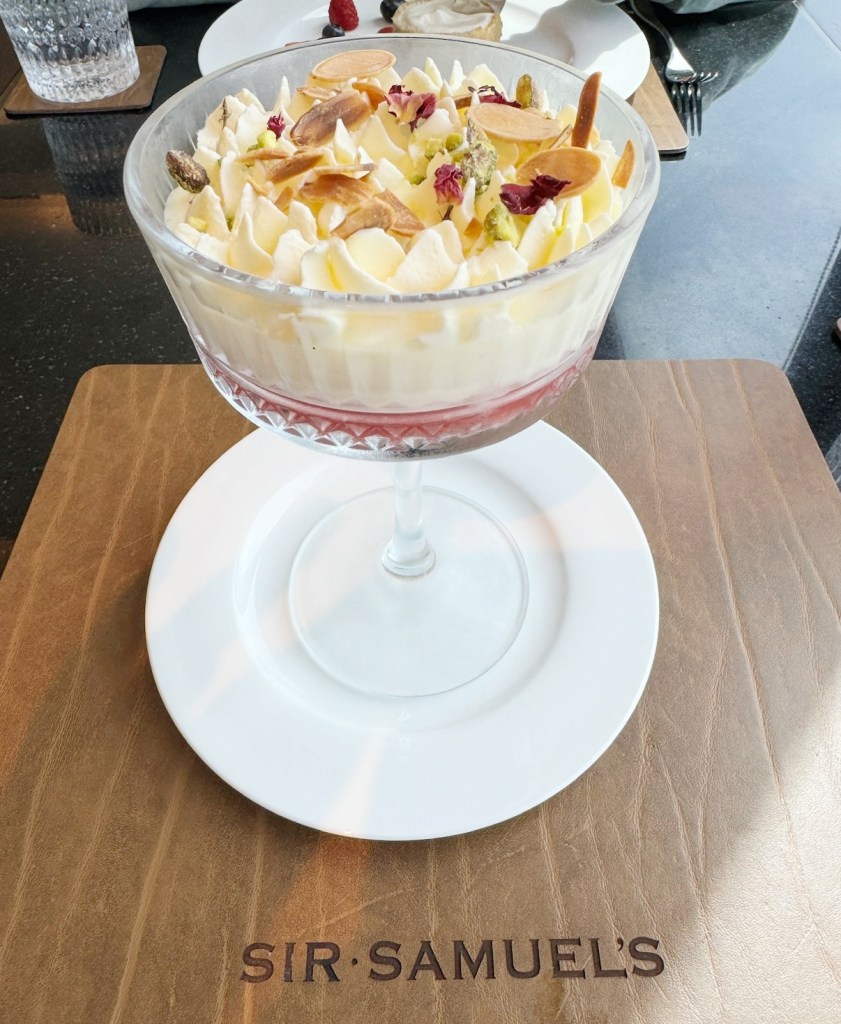 A large Sherry triffle on a wooden effect placemat with Sir Samuel's branding